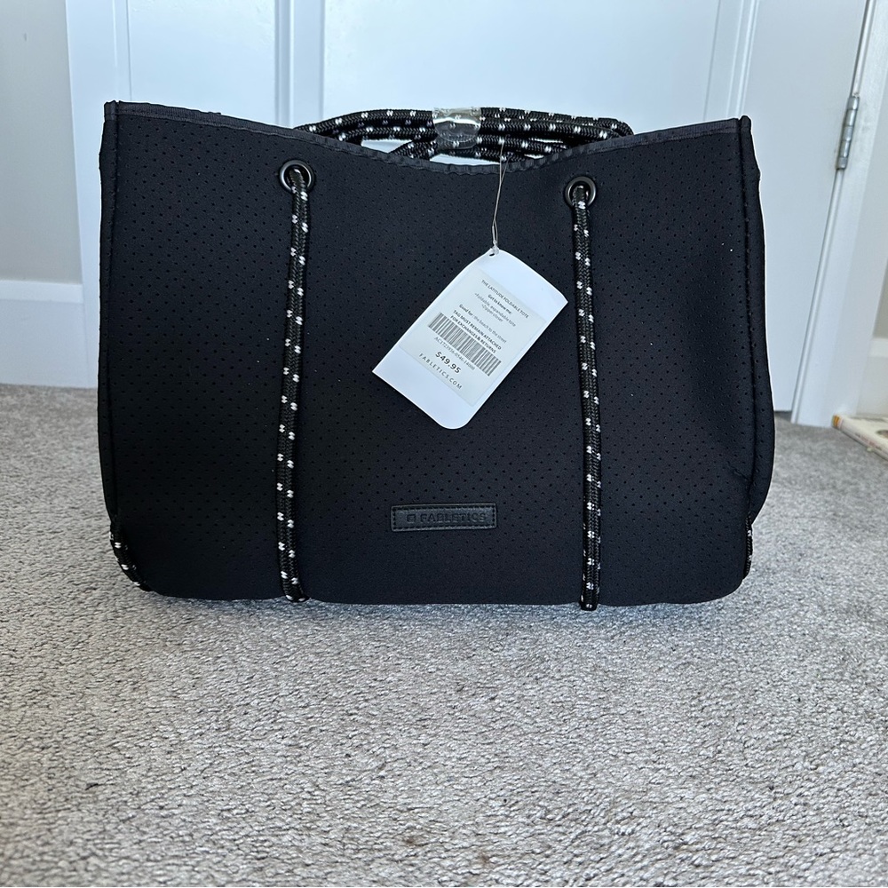 Fabletics foldable, expandable tote with zipper and side straps. Black